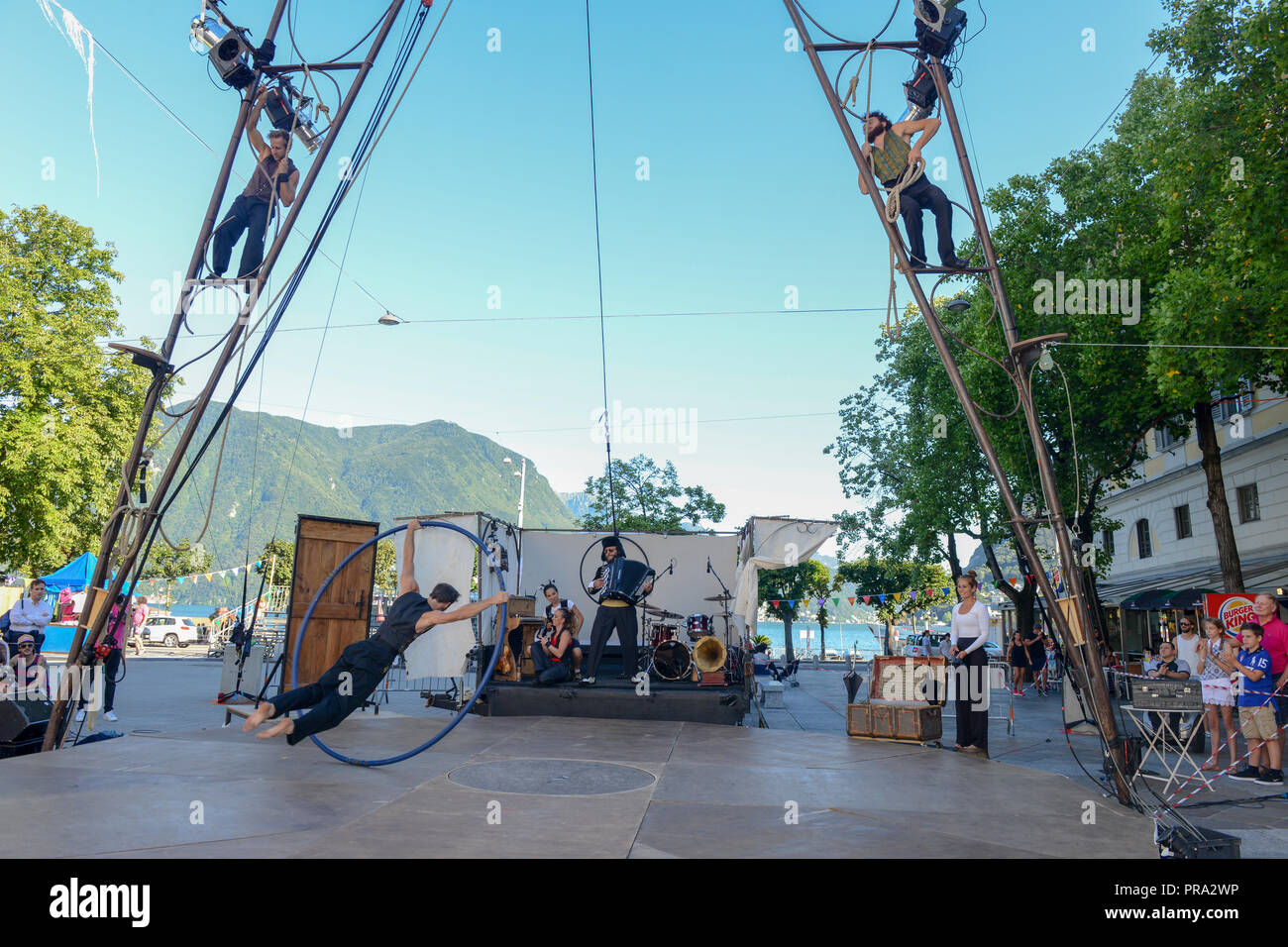 Lugano, Switzerland - 15 July 2016 - Acrobat on a hula hoop does tricks at Buskers Festival in Lugano, Switzerland Stock Photo