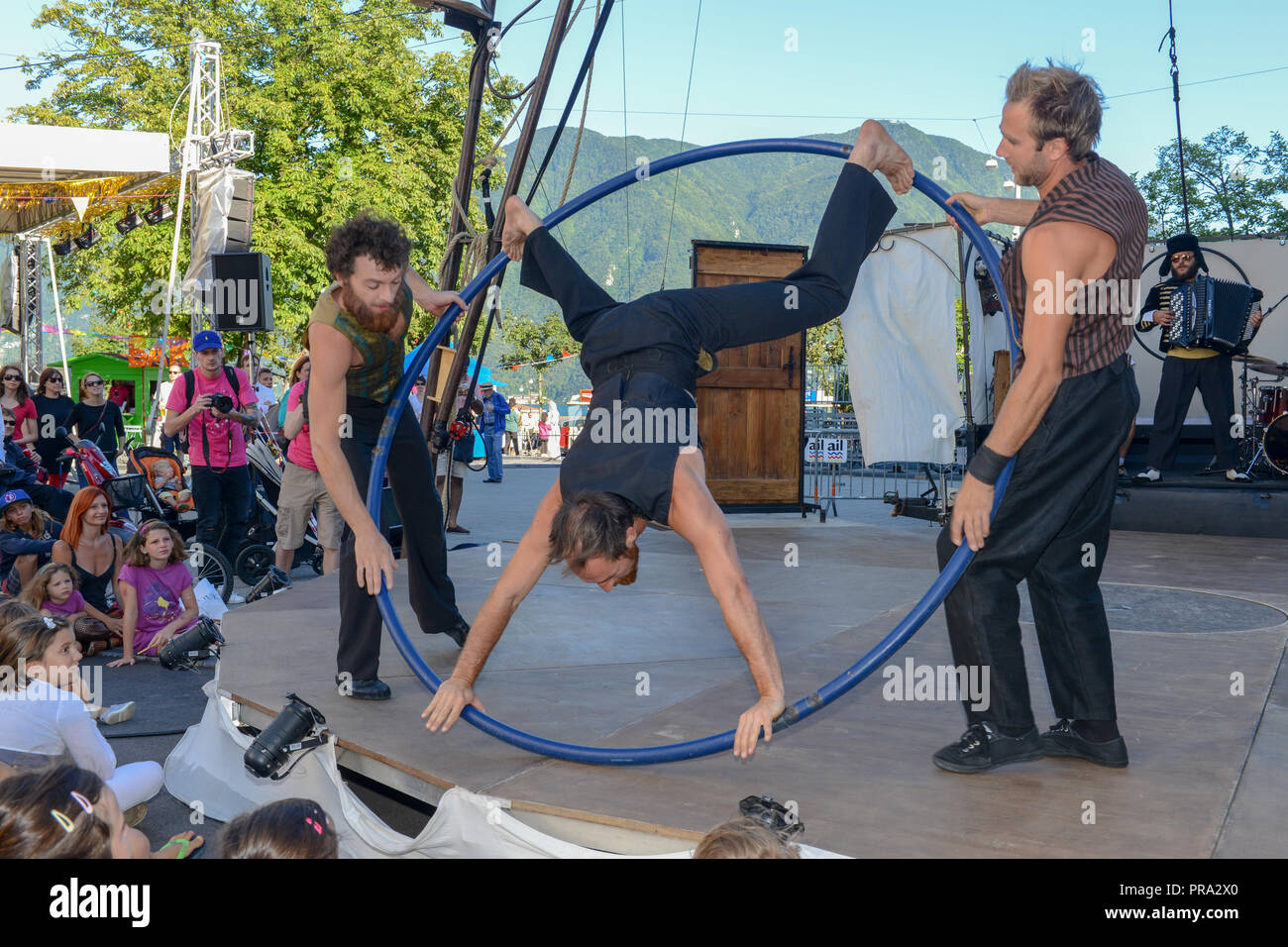Lugano, Switzerland - 15 July 2016 - Acrobat on a hula hoop does tricks at  Buskers Festival in Lugano, Switzerland Stock Photo - Alamy