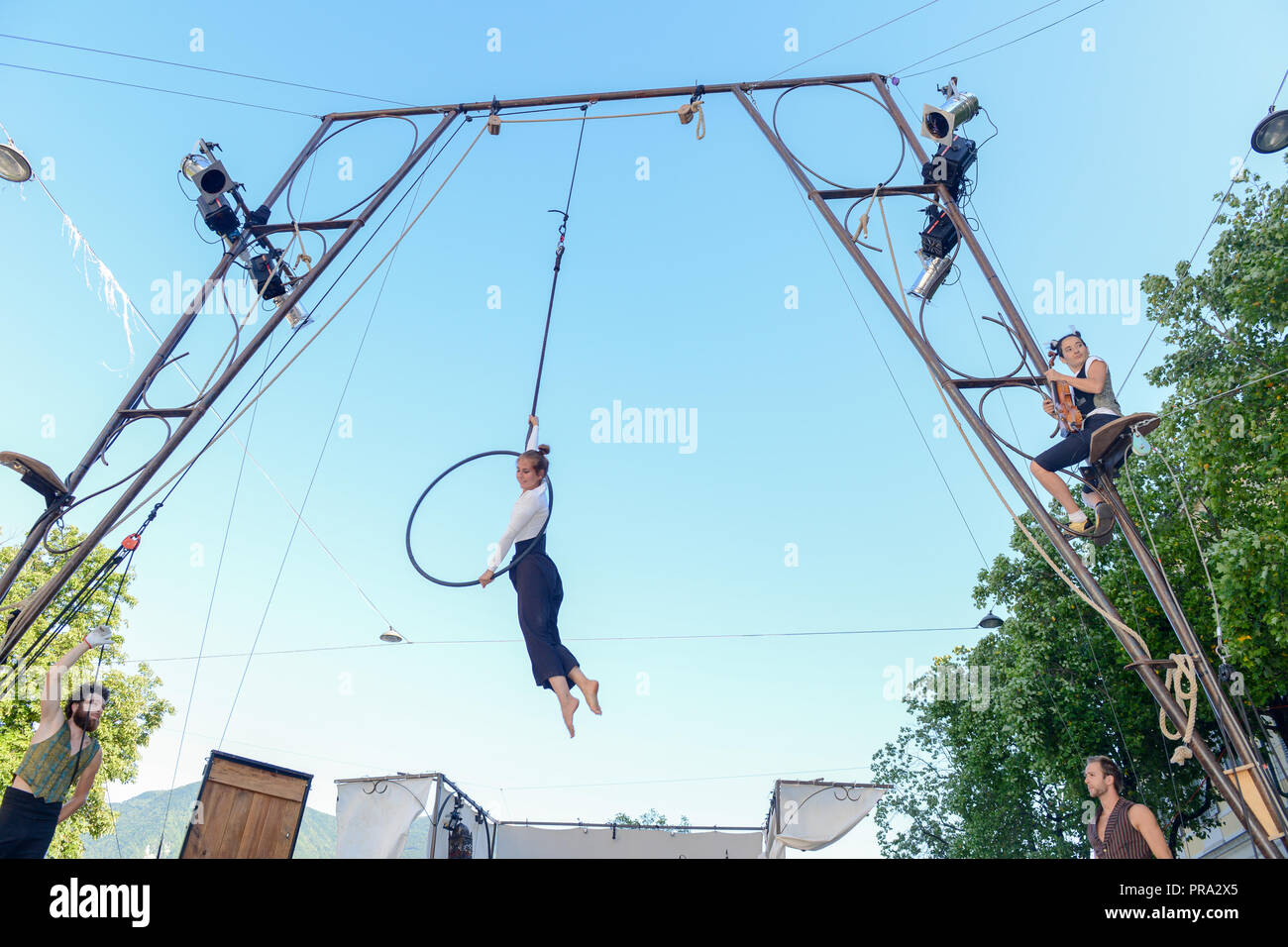 Lugano, Switzerland - 15 July 2016 - Lugano, Switzerland - 15 July 2016 -  Woman acrobat on a hula hoop does tricks at Buskers Festival in Lugano, Swi Stock Photo