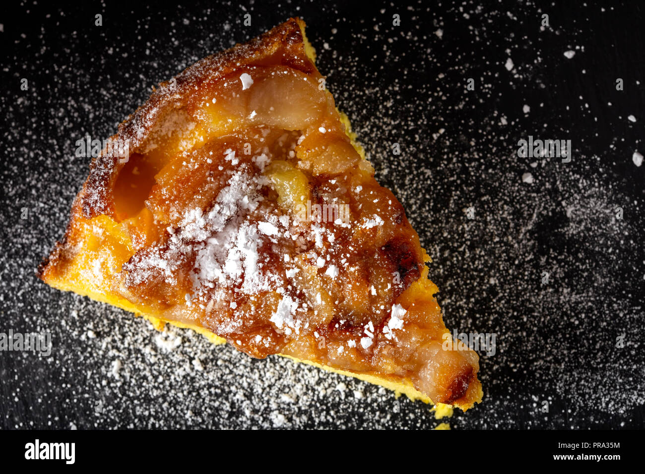 One slice of an apple cake with powder sugar - top view Stock Photo