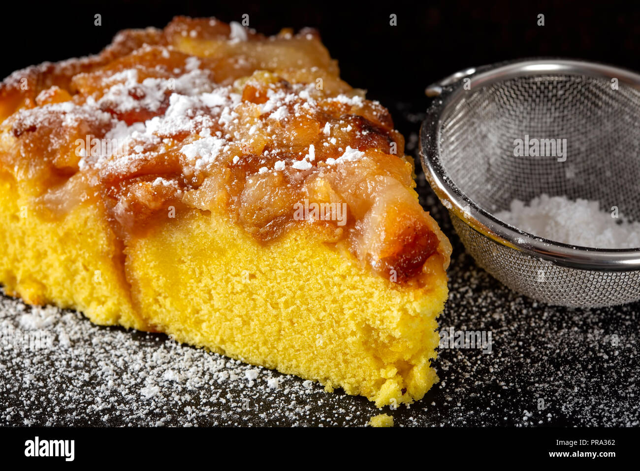 One slice of an apple cake with powder sugar - close up view Stock Photo