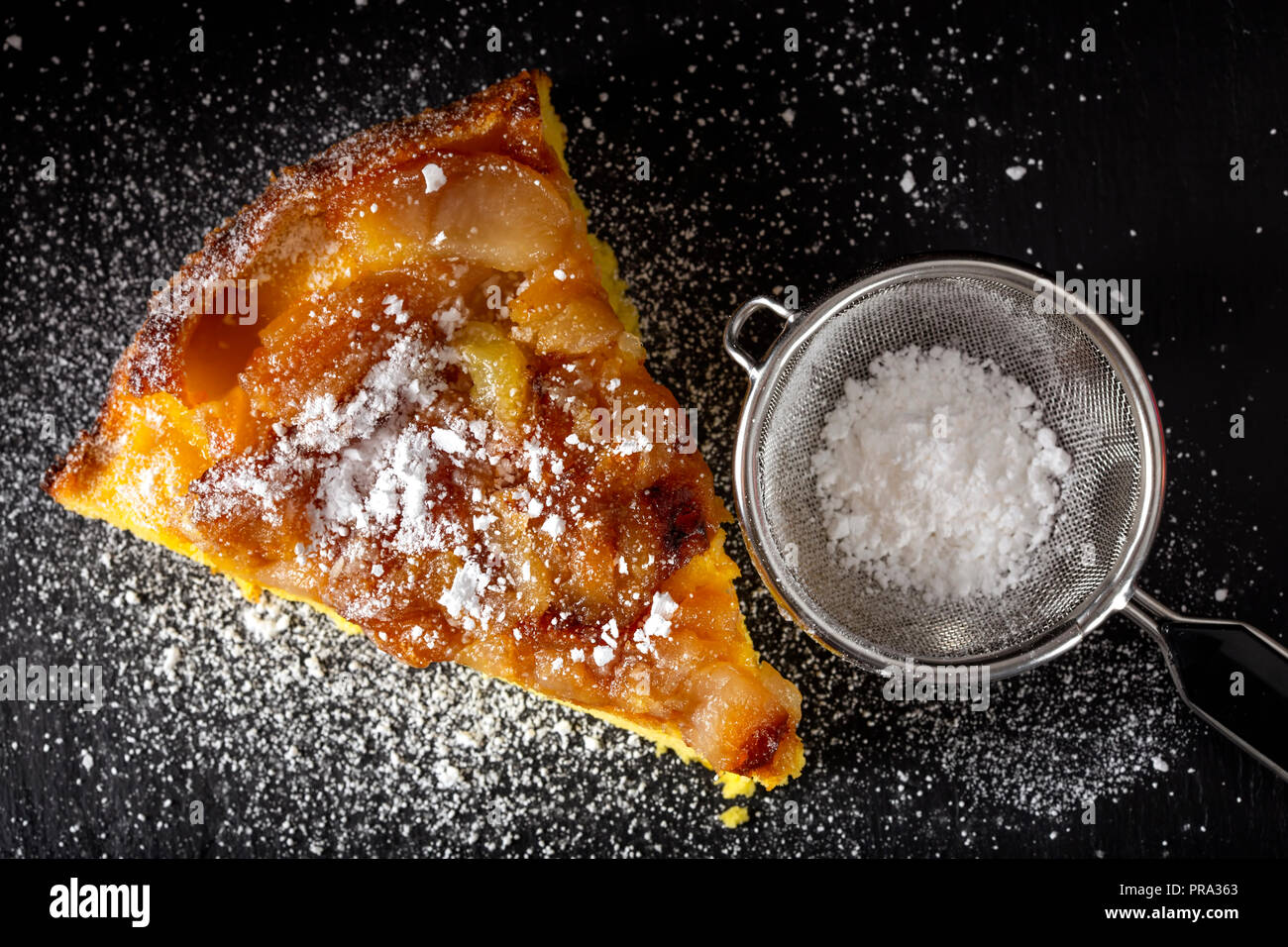 One slice of an apple cake with powder sugar - top view Stock Photo