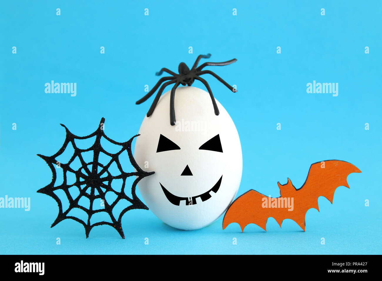 minimal and funny Halloween holiday concept. White egg with scary cute face, spiderweb, bat and spider on top Stock Photo - Alamy minimal and funny Halloween holiday concept. White egg with scary cute face, spiderweb, bat and spider on top Stock Photo - Alamy