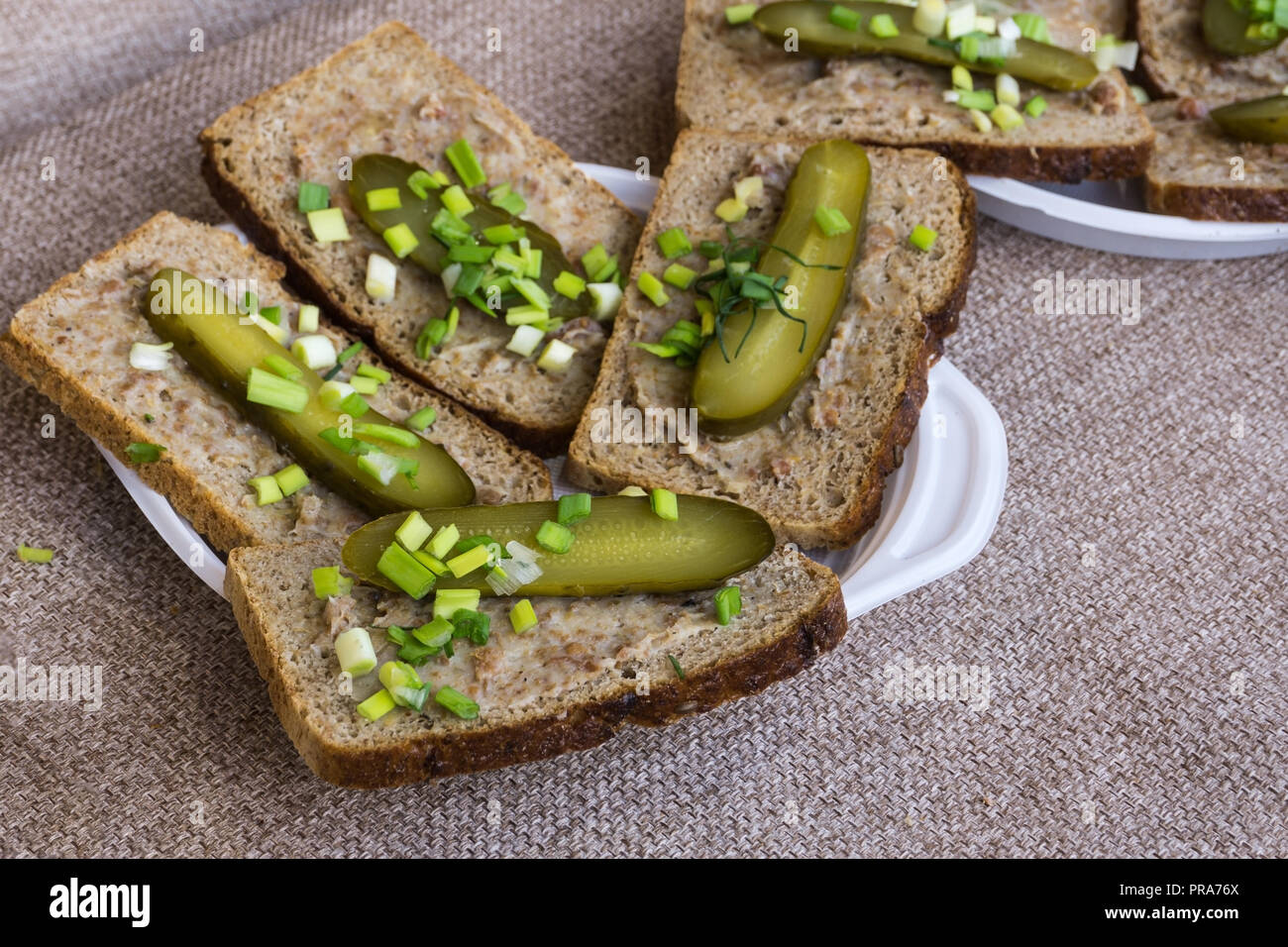 Homemade lard and pickled gherkin on a slices of bread. Traditional