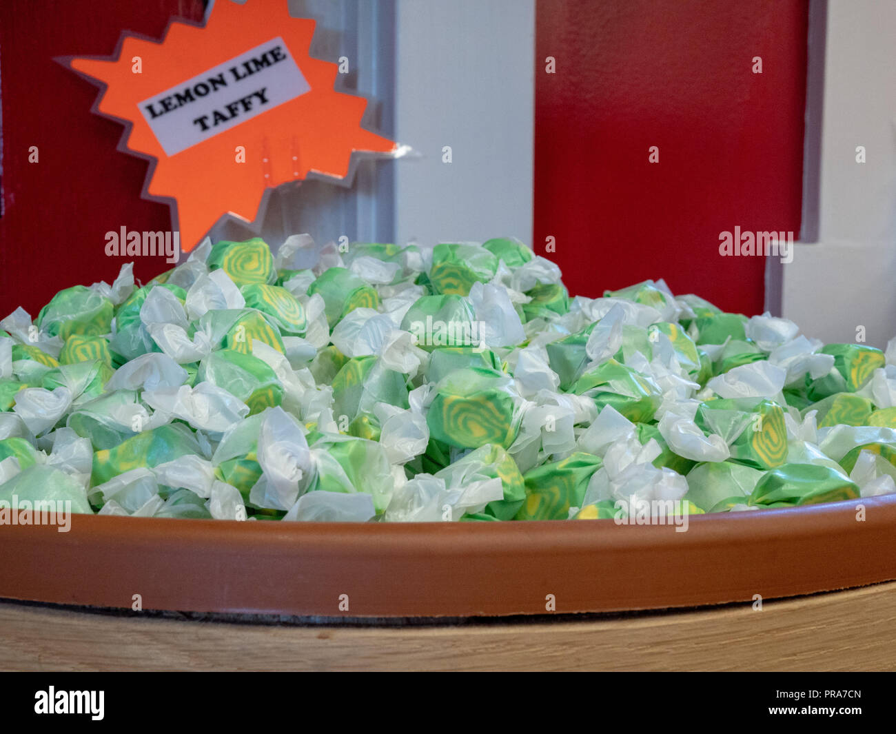 Lemon lime flavored taffy piled in a barrel with sign in store Stock Photo