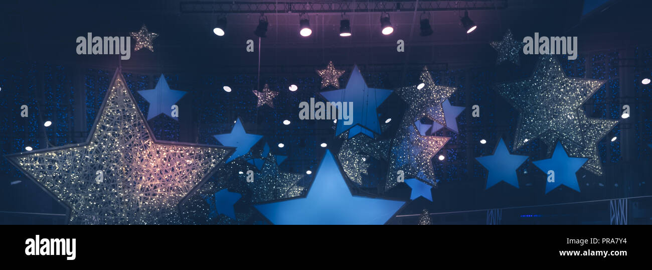 shining stars shape spotlights soffits night vintage show stage performance background with gradient dark blue pink lilac purple lights Stock Photo