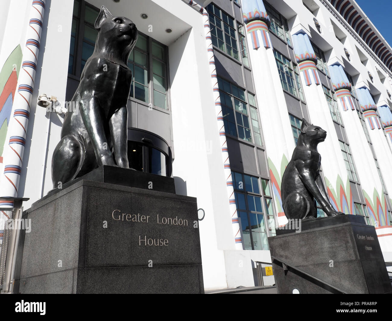 A view of the black cats on guard in front of Greater London House formerly the Carreras Cigarette Factory a large art deco building in Camden London Stock Photo