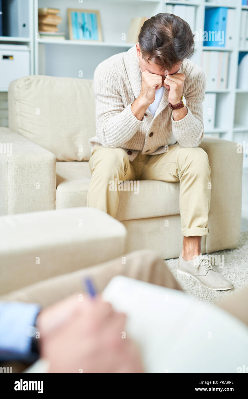 Crying Man in Therapy Stock Photo
