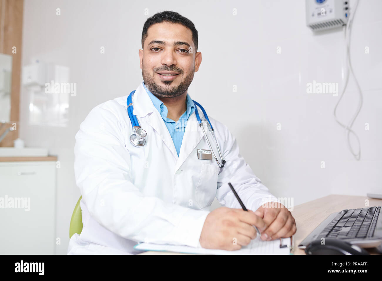 Middle-Eastern Doctor Posing at Workplace Stock Photo