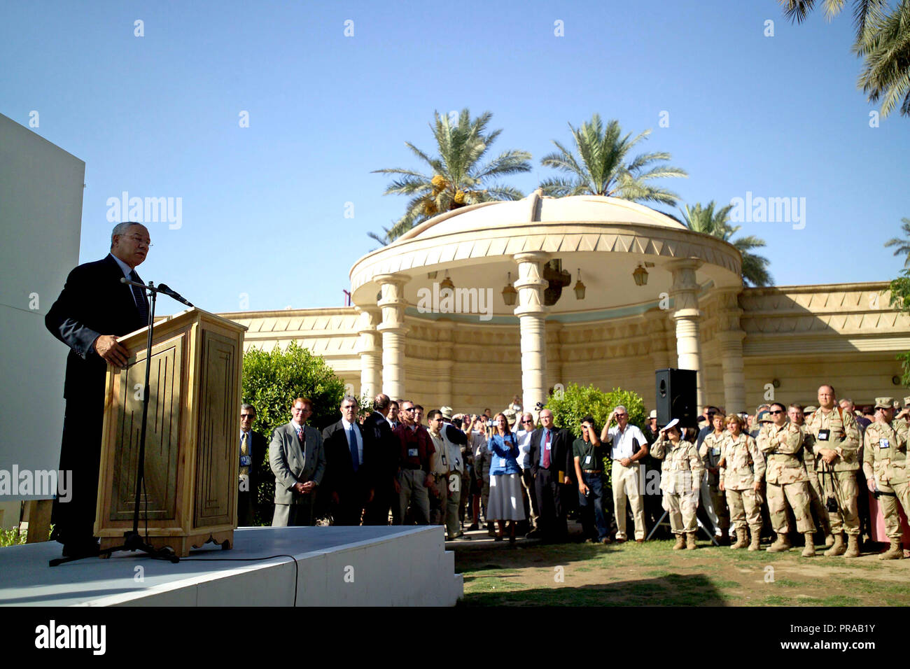 The Honorable Colin L. Powell (left), US Secretary of State, addresses an audience outside the
