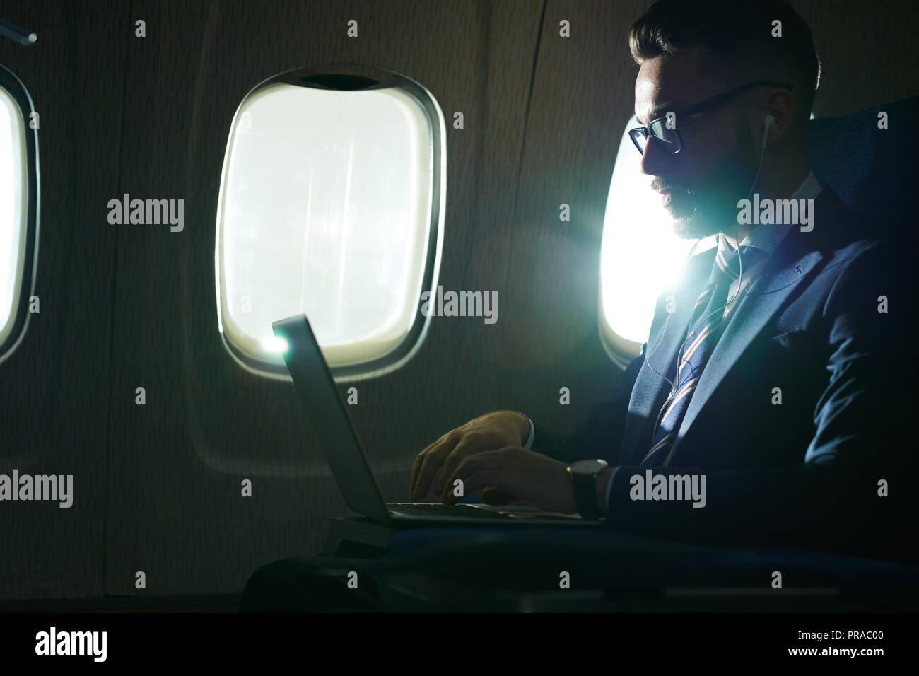 Businessman Working in Flight Stock Photo