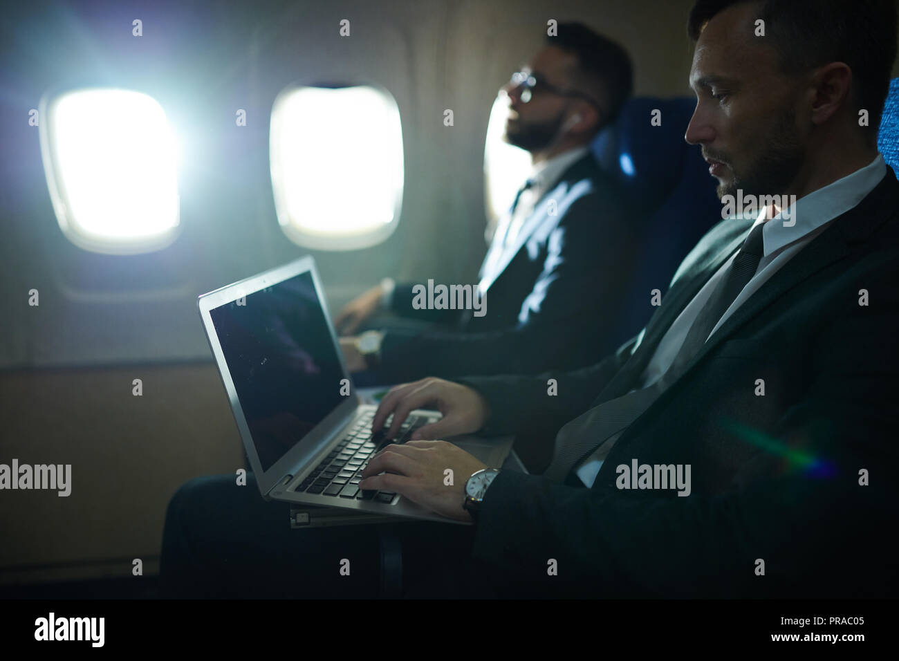 Business People in Plane Stock Photo