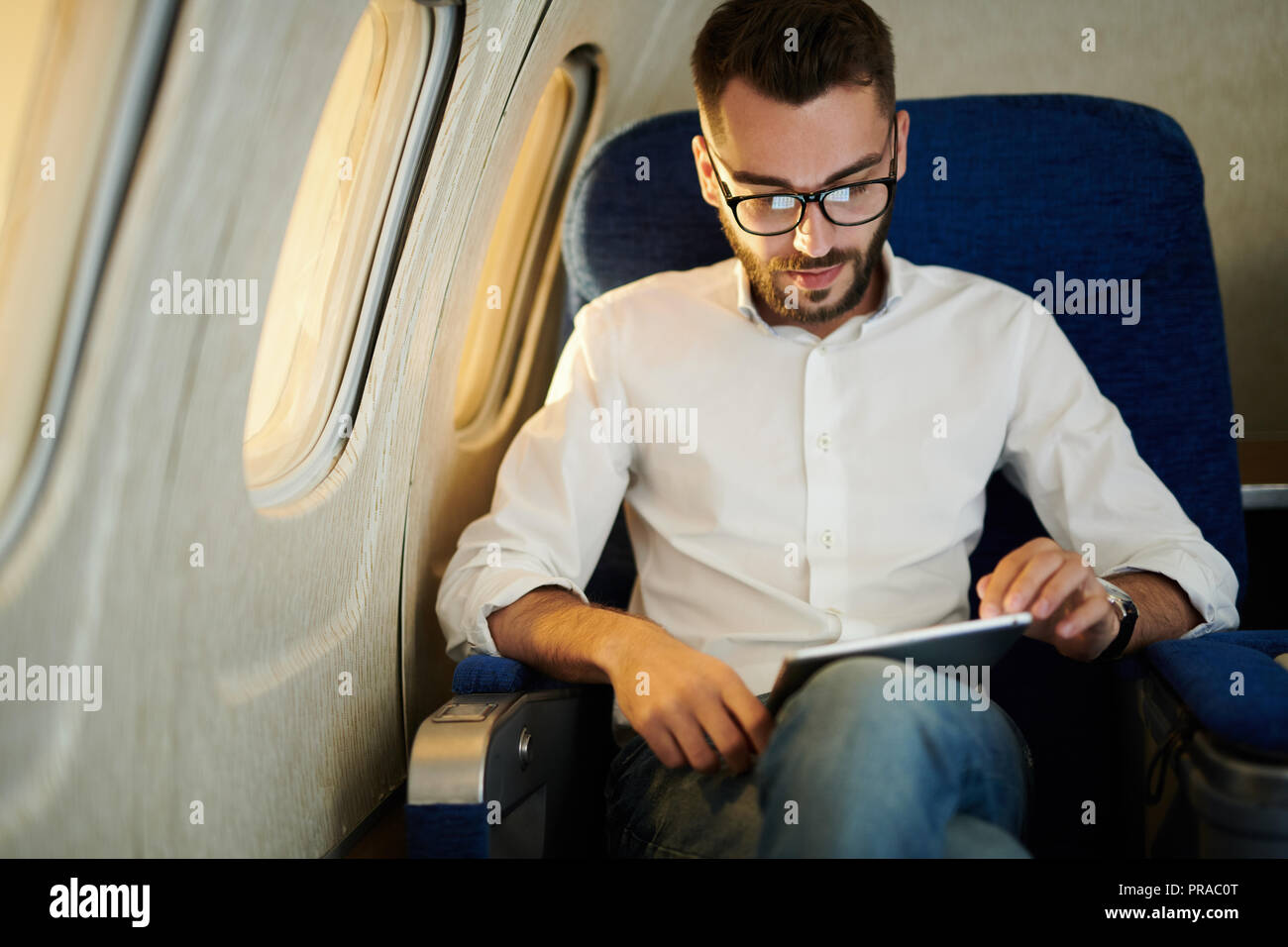 Man in Window Seat Stock Photo