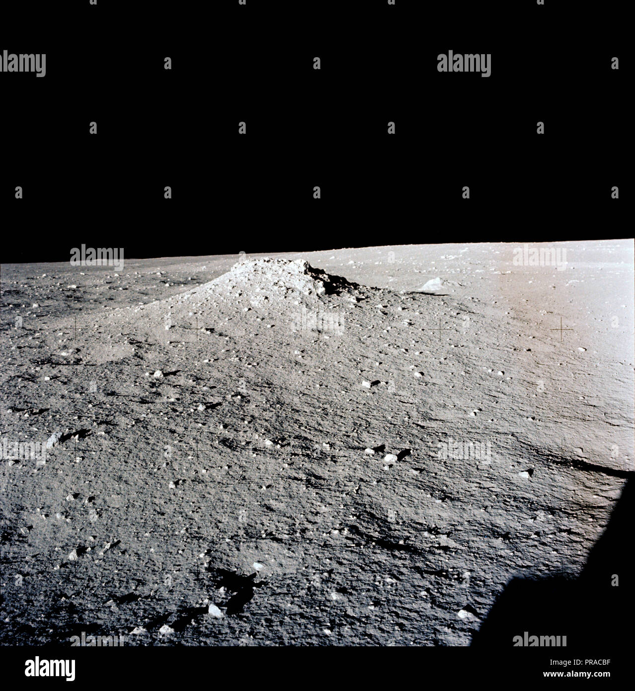 AS12-46-6795 (19-20 Nov. 1969) --- A view of the lunar surface in the vicinity of the Apollo 12 lunar landing site, photographed during the extravehicular activity (EVA) of astronauts Charles Conrad Jr., commander, and Alan L. Bean, lunar module pilot. Conrad and Bean encountered the odd, anthill-shaped mound during their lunar traverse. The two descended in the Apollo 12 Lunar Module (LM) to explore the moon, while astronaut Richard F. Gordon Jr., command module pilot, remained with the Command and Service Modules (CSM) in lunar orbit. Stock Photo