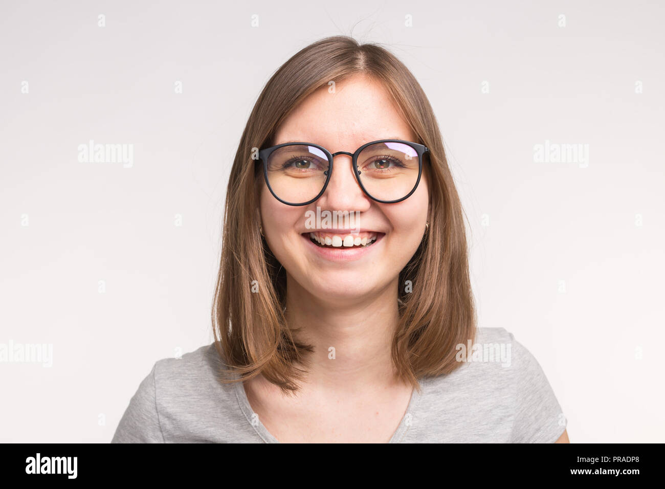 Portrait Of White Young Woman With Short Brown Hair In A Glasses