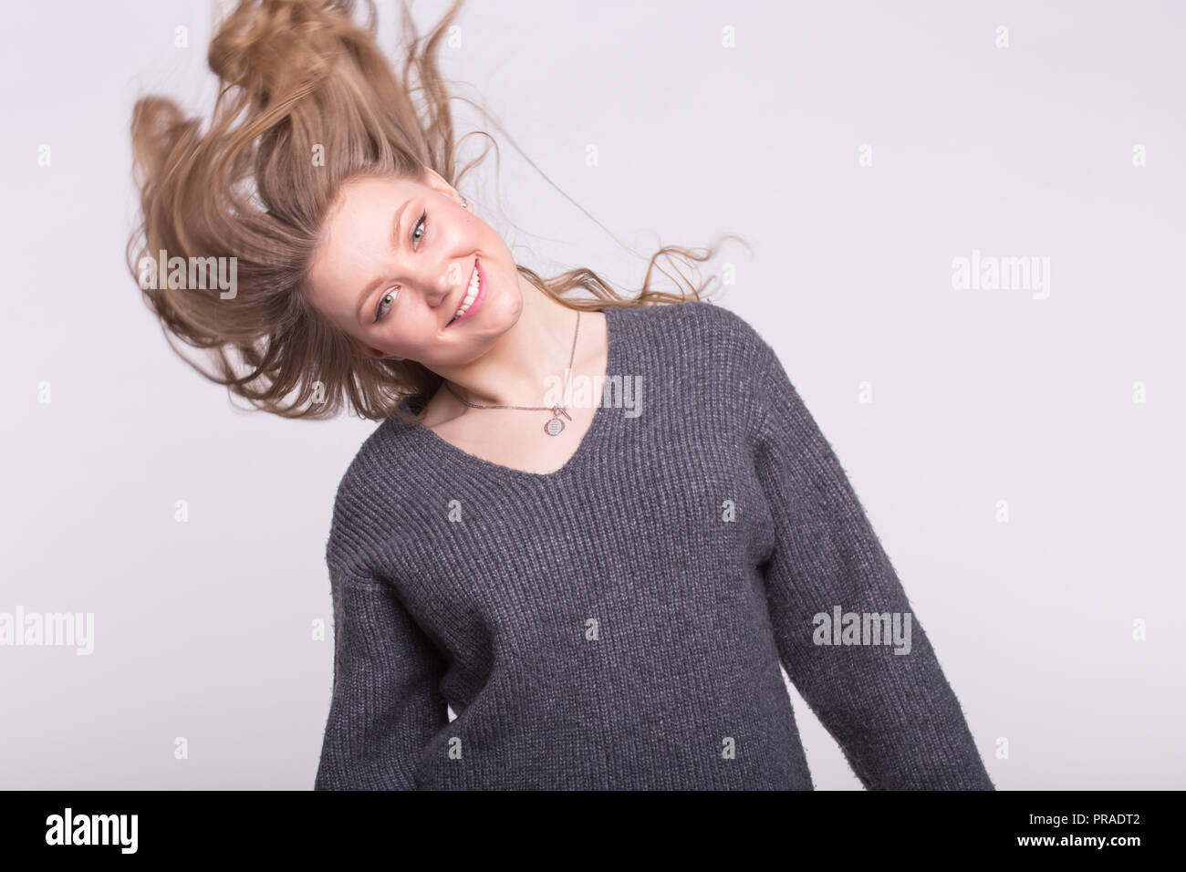 Pretty young blonde woman dancing over white background Stock Photo - Alamy