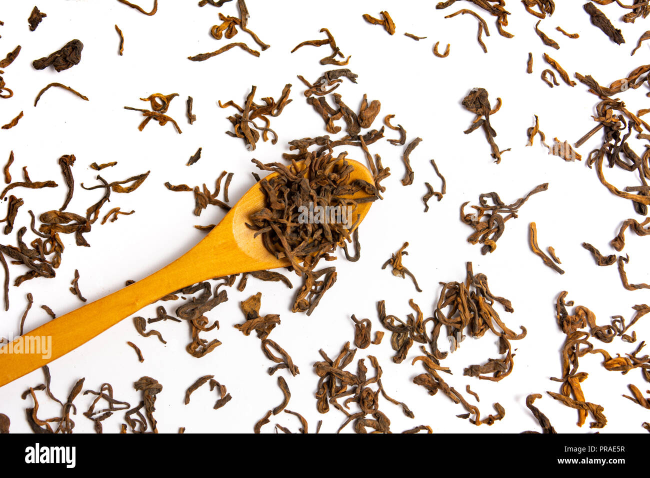 Green herbal tea with a wooden spoon on white background Stock Photo