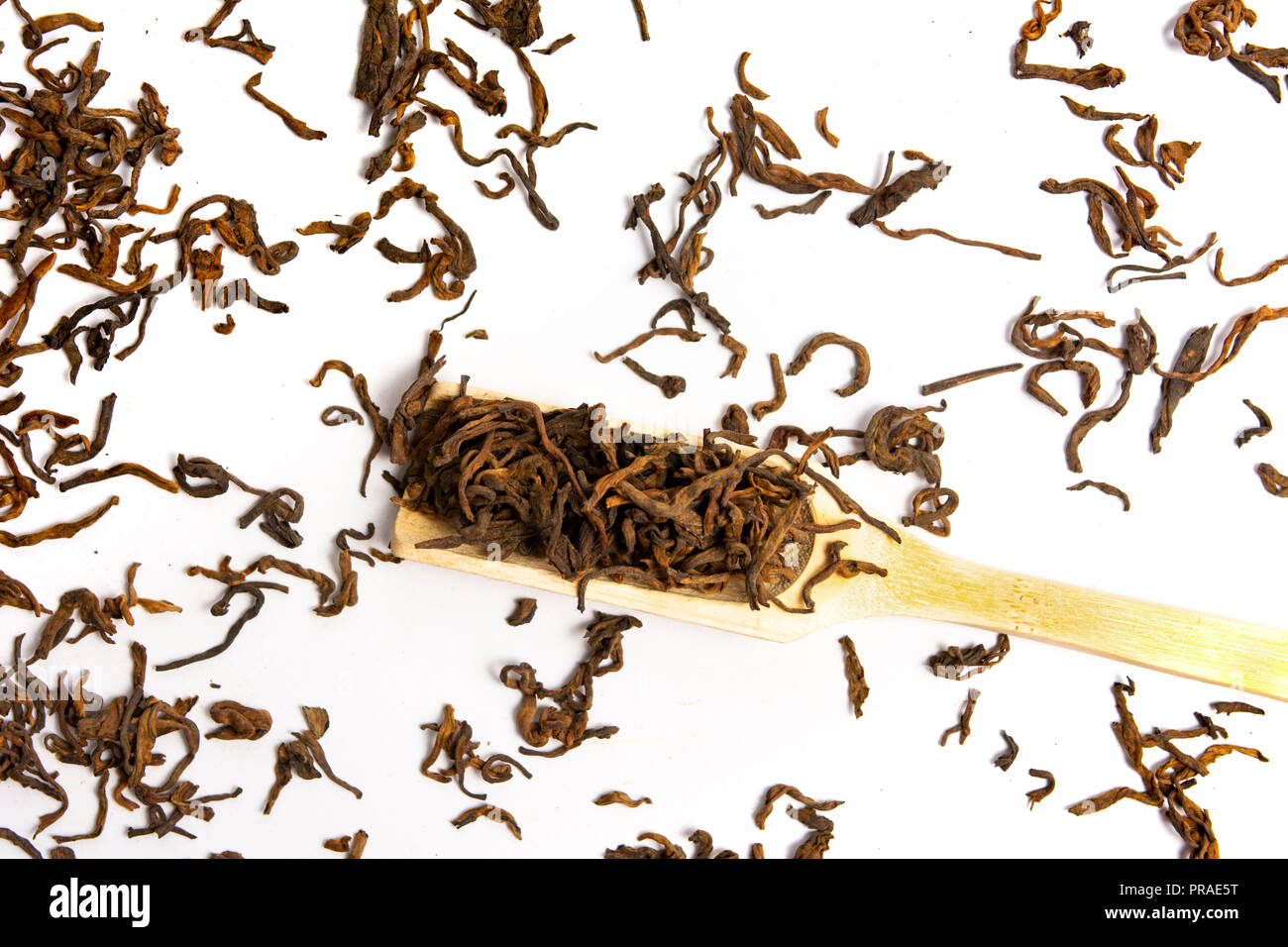 Green herbal tea with a wooden spoon on white background Stock Photo