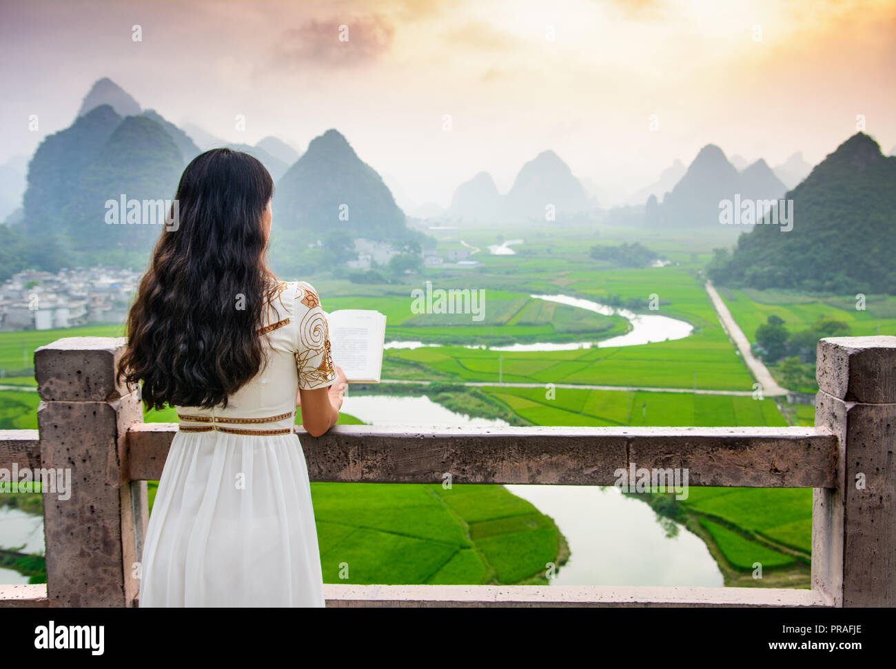 Girl reading book with nice mountain view in the nature Stock Photo