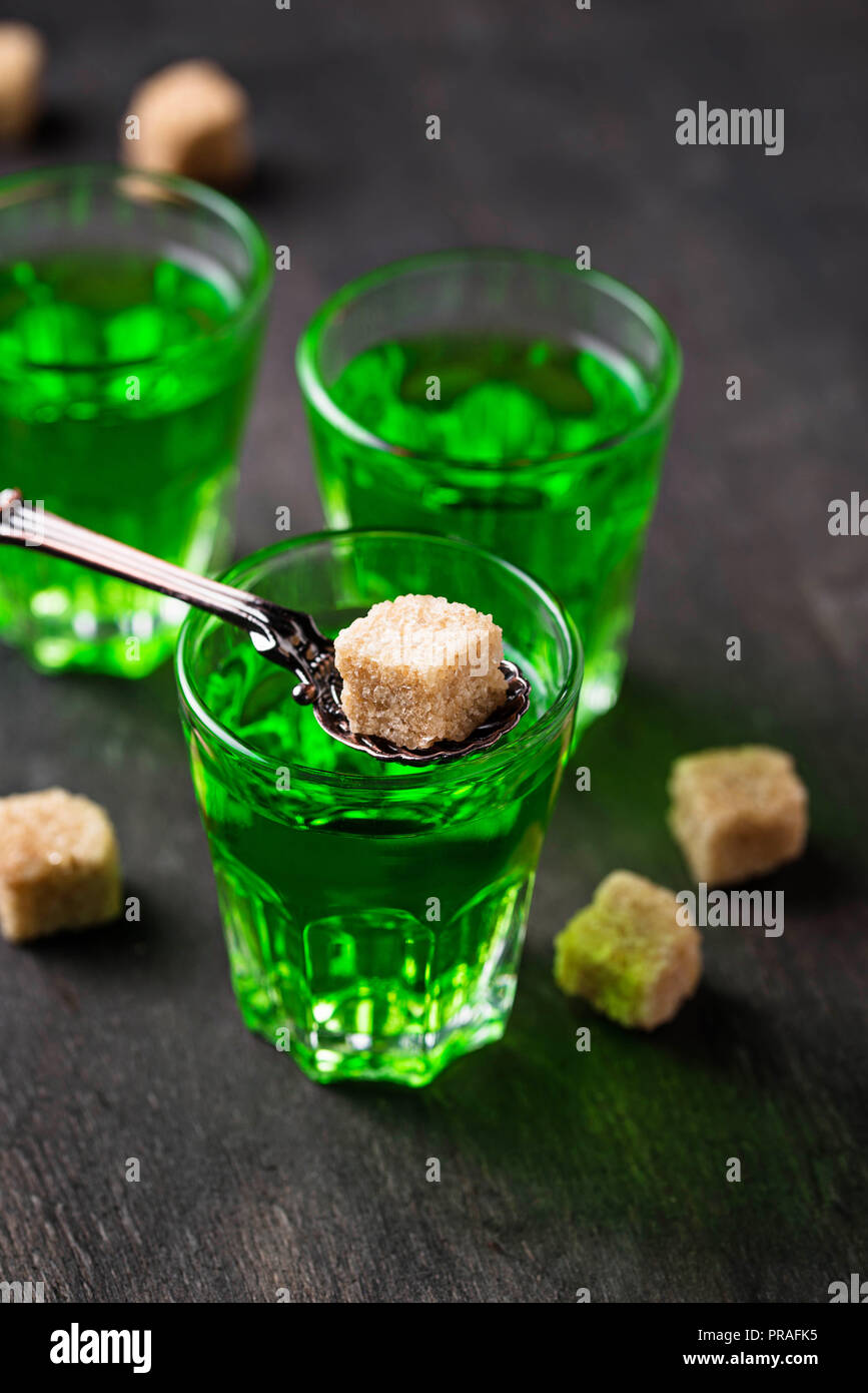 Glasses of absinthe with brown sugar  Stock Photo