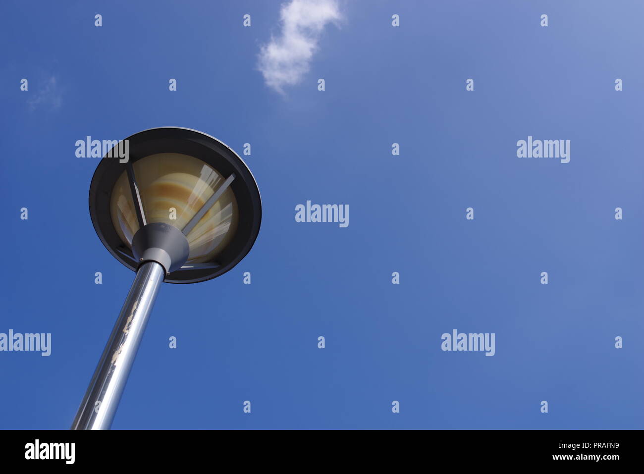a street lamp post with blue sky and white cloud. time to walk or trip Stock Photo