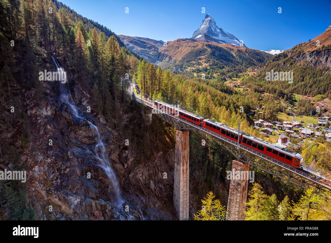 Zermatt, Switzerland. Image of Swiss Alps with Gornergrad tourist train, waterfall and Matterhorn in Valais region. Stock Photo