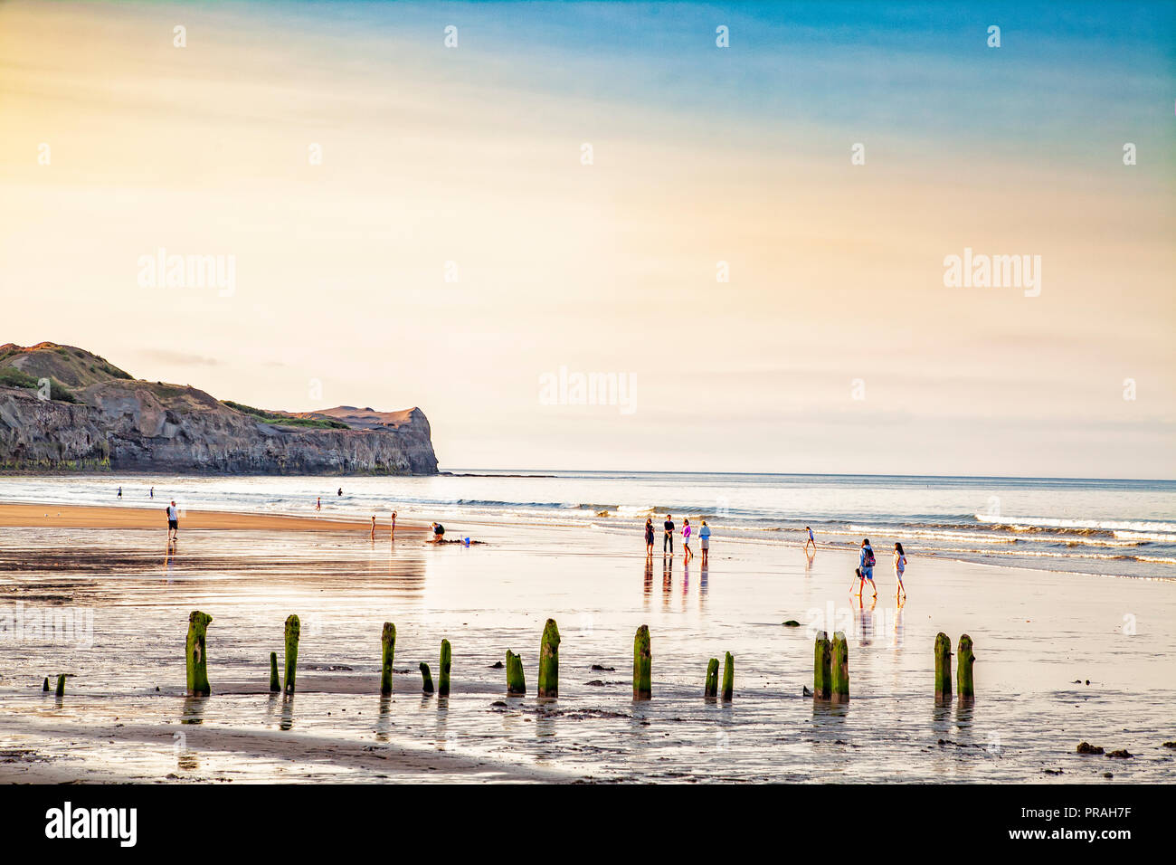 children playing on sunset beach at sandsend, whitby, north yorkshire, britain Stock Photo