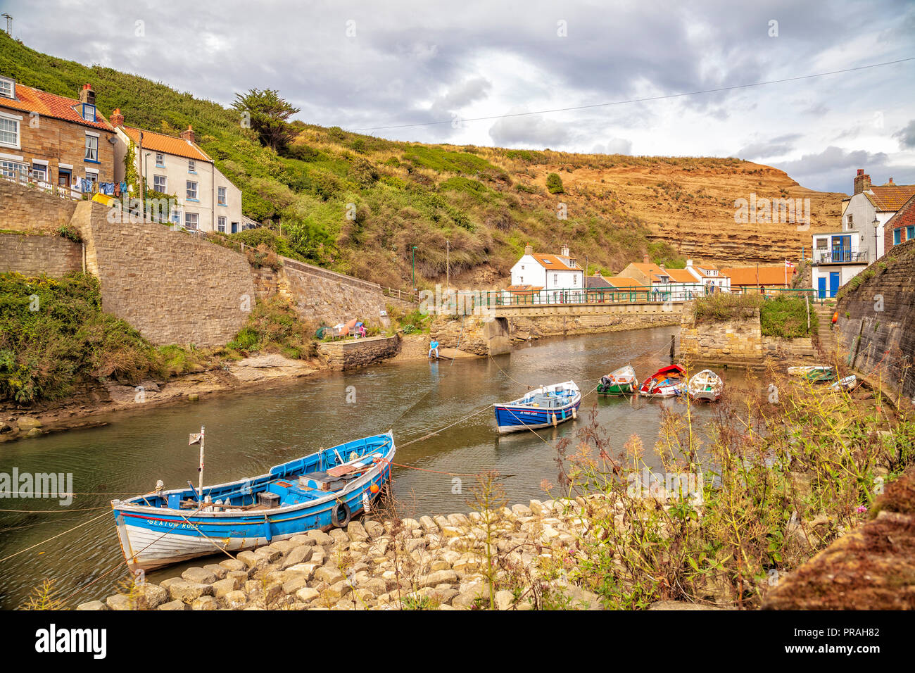 fishing boats in the river at Staithes, Scarborough, North Yorkshire Coast Stock Photo