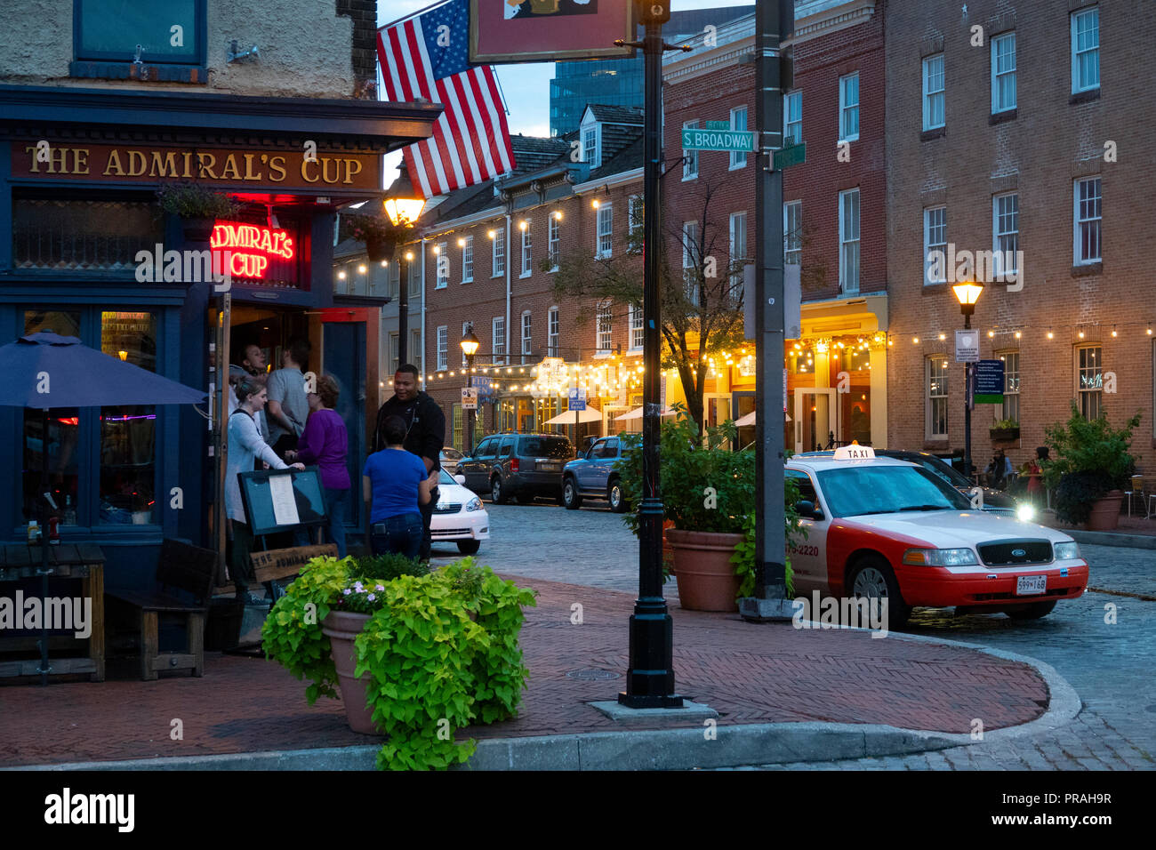 USA Baltimore Fells Point outside The Admirals Cup bar tavern on Thames Street evening taxi Stock Photo