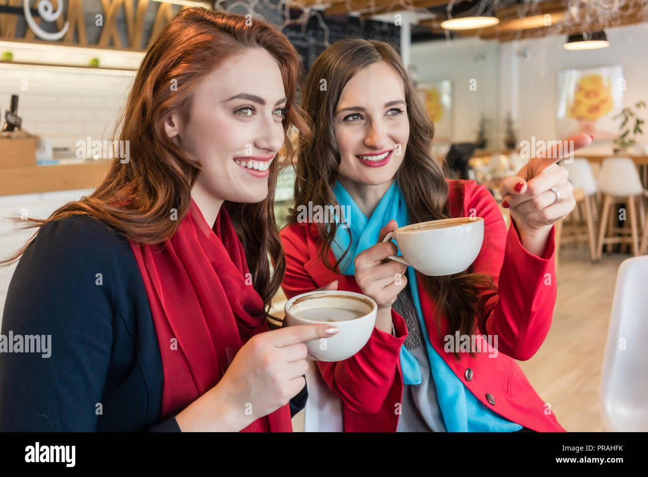Two women friends drinking hot hi-res stock photography and images - Alamy