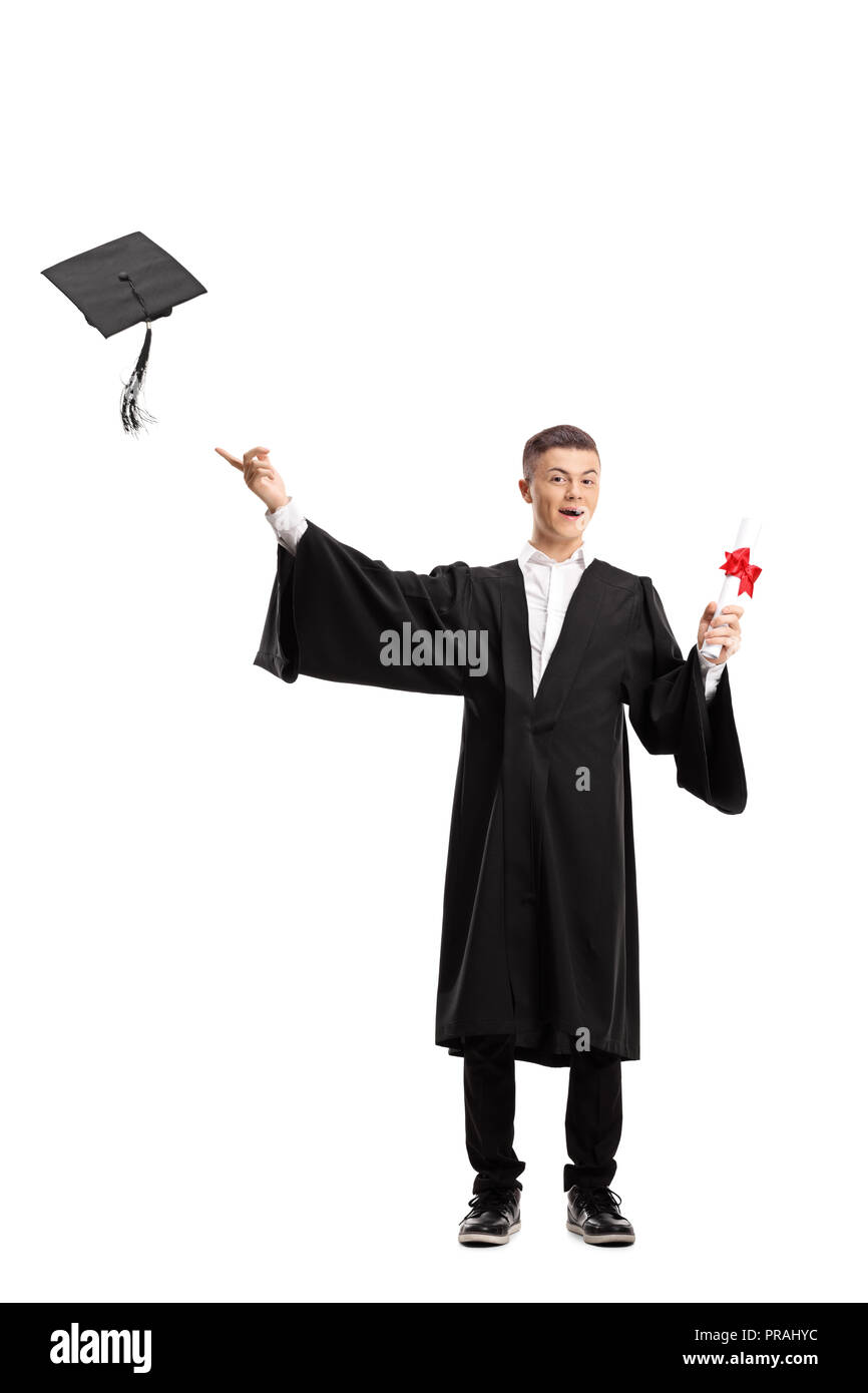 Full length portrait of a graduate student holding a diploma and throwing a graduation hat isolated on white background Stock Photo