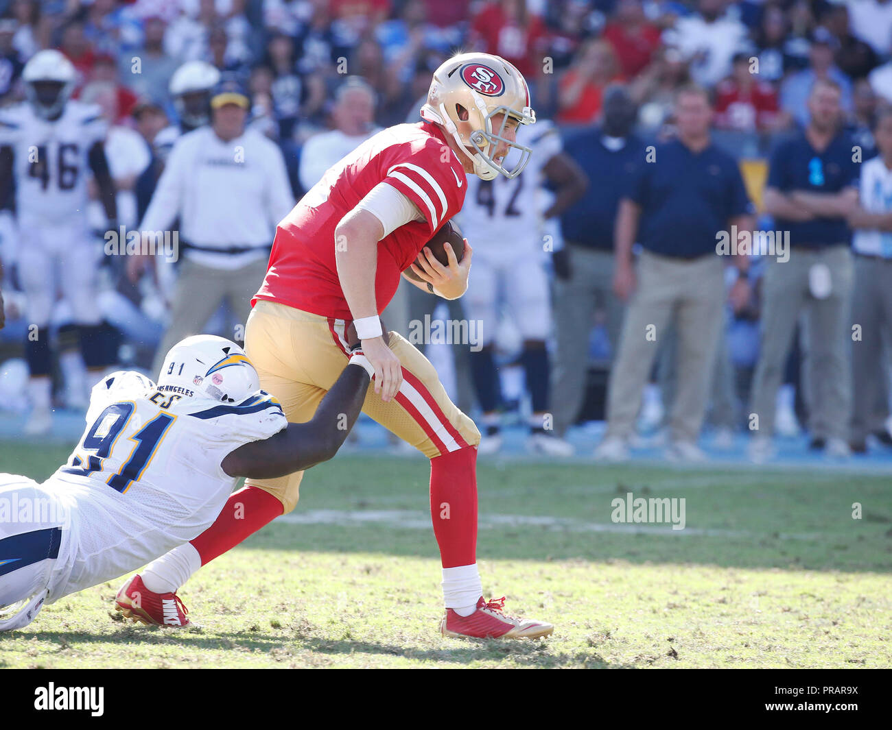 Carson, California, USA. 30th Sept, 2018. September 30, 2018 San Francisco  49ers quarterback C.J. Beathard (3) scrambles with the ball as Los Angeles  Chargers defensive tackle Justin Jones (91) makes the tackle