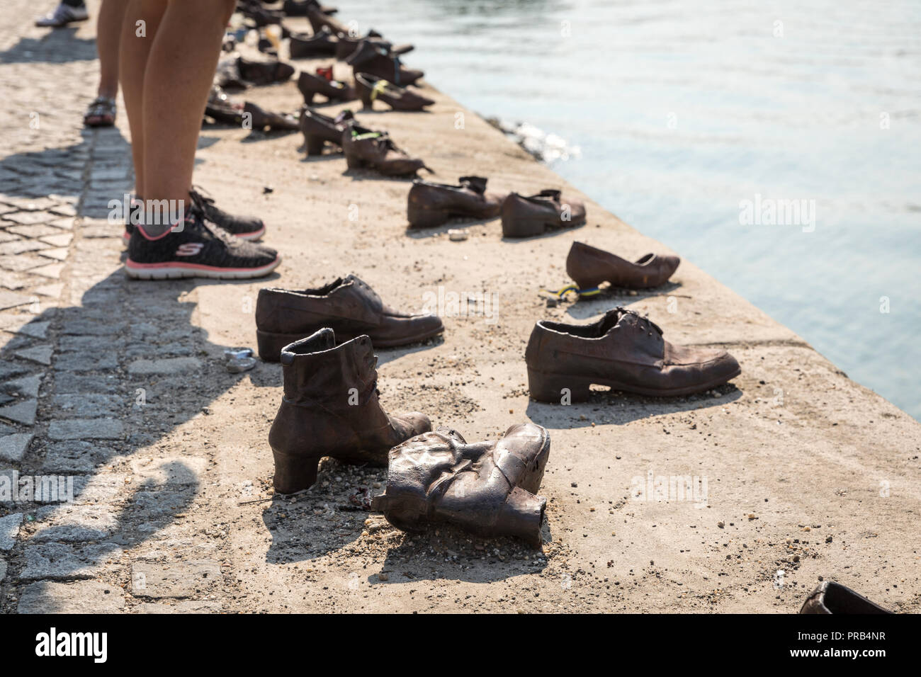 A poignant memorial on the bank of the Danube in Budapest are these cast iron shoes sculpted by Gyula Pauer and conceived by Can Togay. The shoes comm Stock Photo