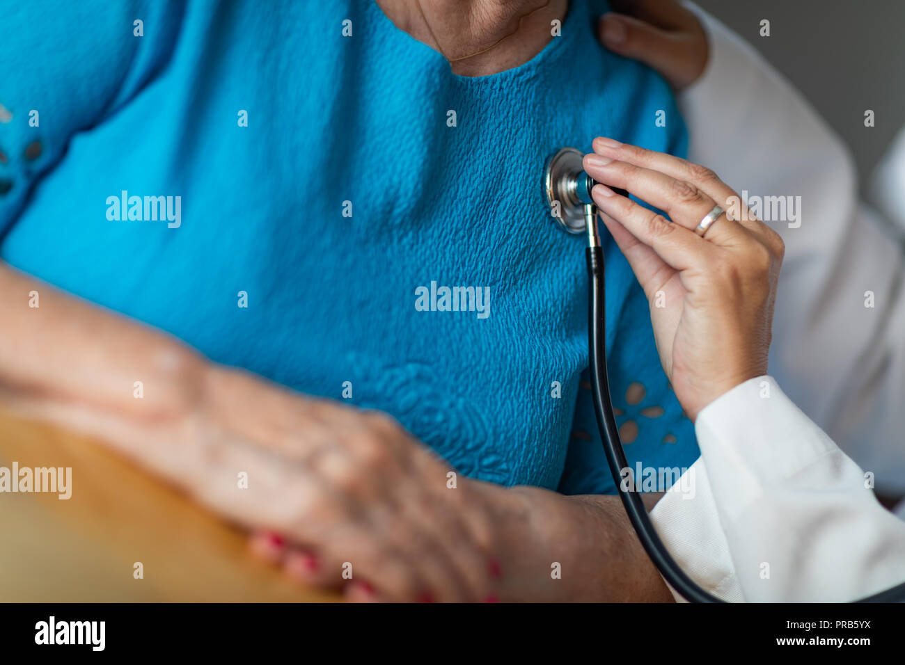 Female Doctor Checking The Heart With Stethoscope of Senior Adult Woman ...