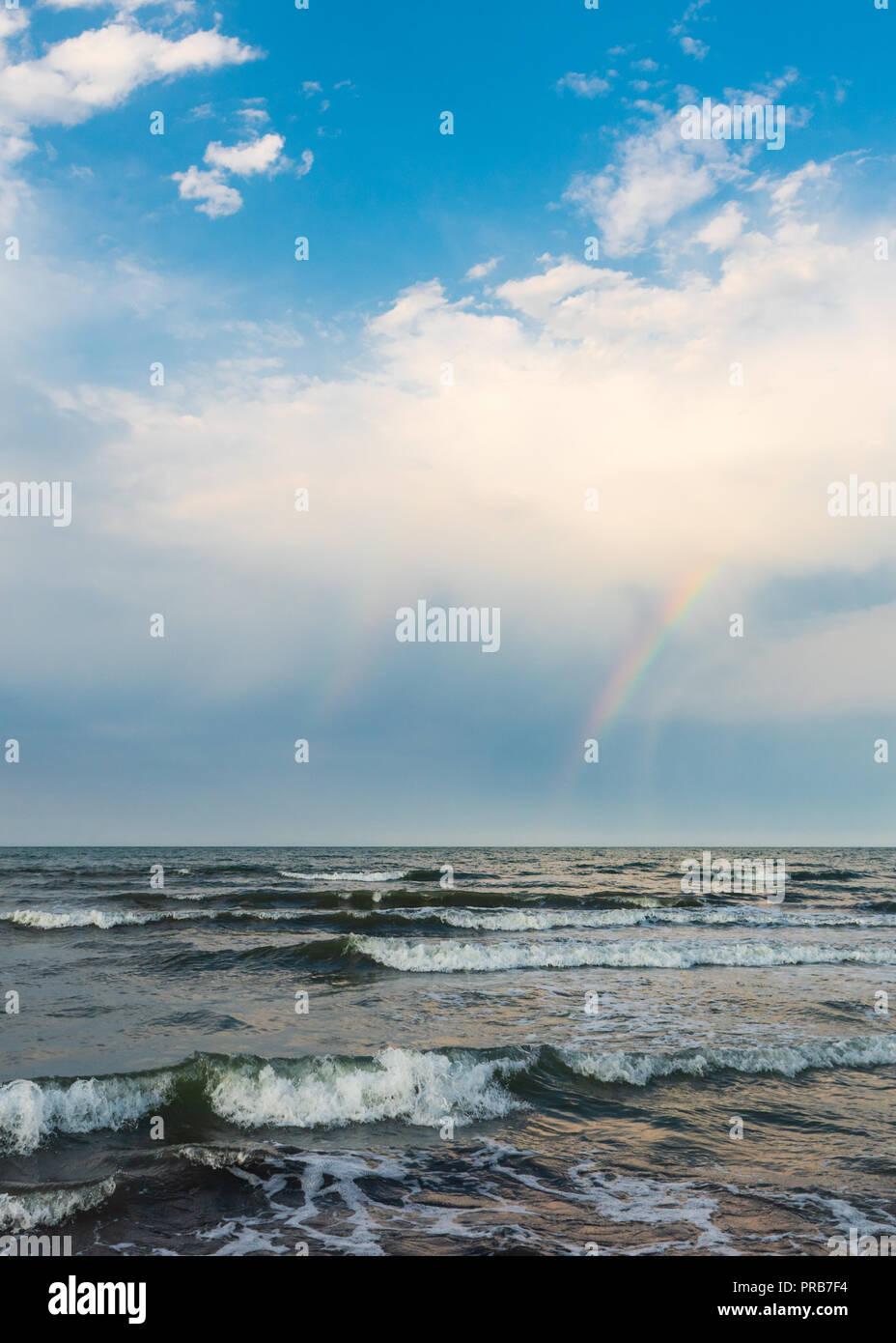 Rainbow over the sea after rain Stock Photo - Alamy
