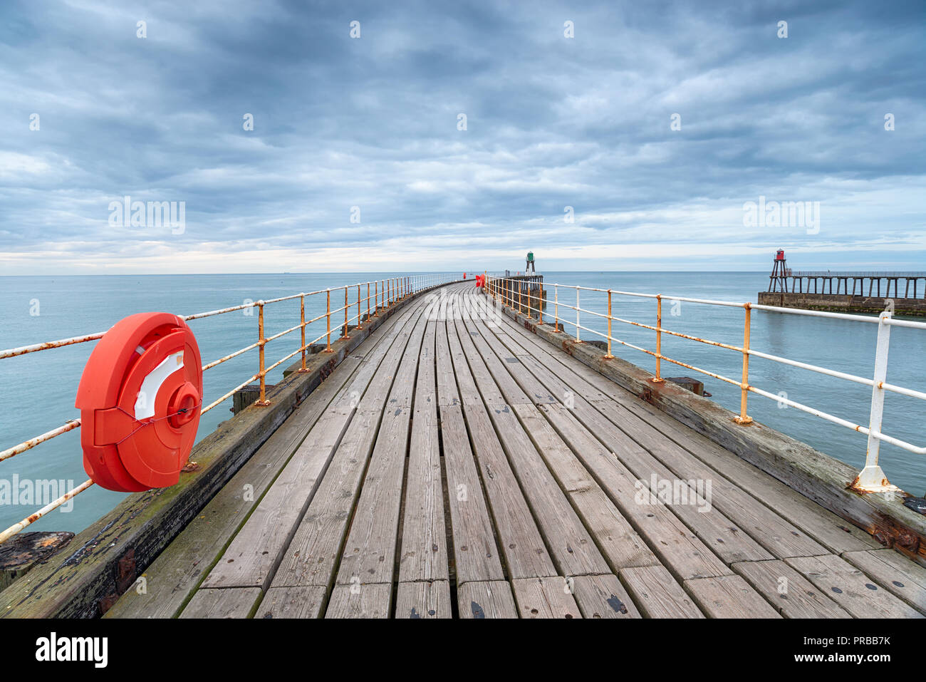 Moody skies over the West Pier at Whitby on the Yorkshire coast Stock Photo