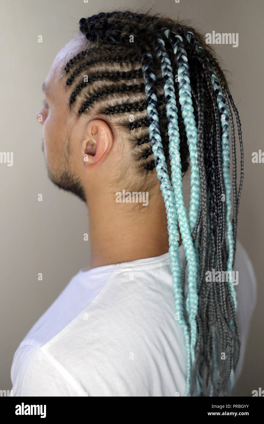thin braids in African style, French braids on the head of a man Stock Photo