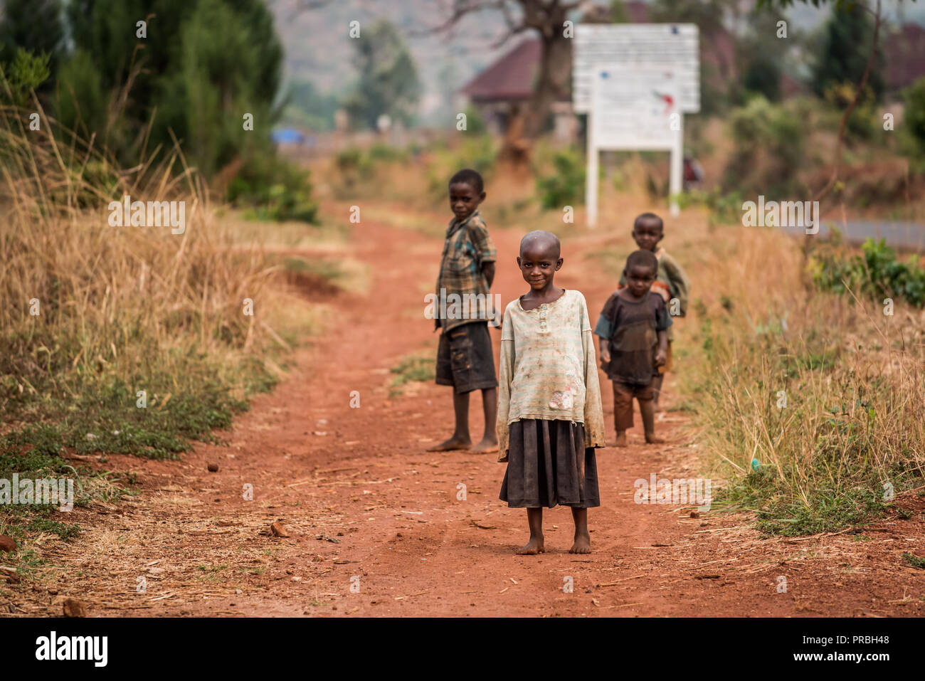 Children from Burundi on a dusty road Stock Photo