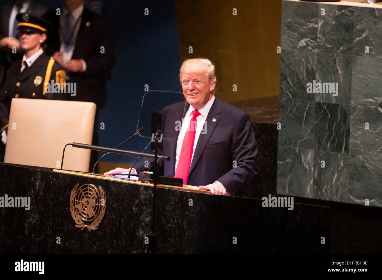 U.S President Donald Trump chuckles during his address to the 73rd session of the U.N. General Assembly at the United Nations Headquarters September 25, 2018 in New York, New York. Trump was responding after the audience of world leaders openly laughed at Trump after bragging that he 'accomplished more than any American President in history'. Stock Photo