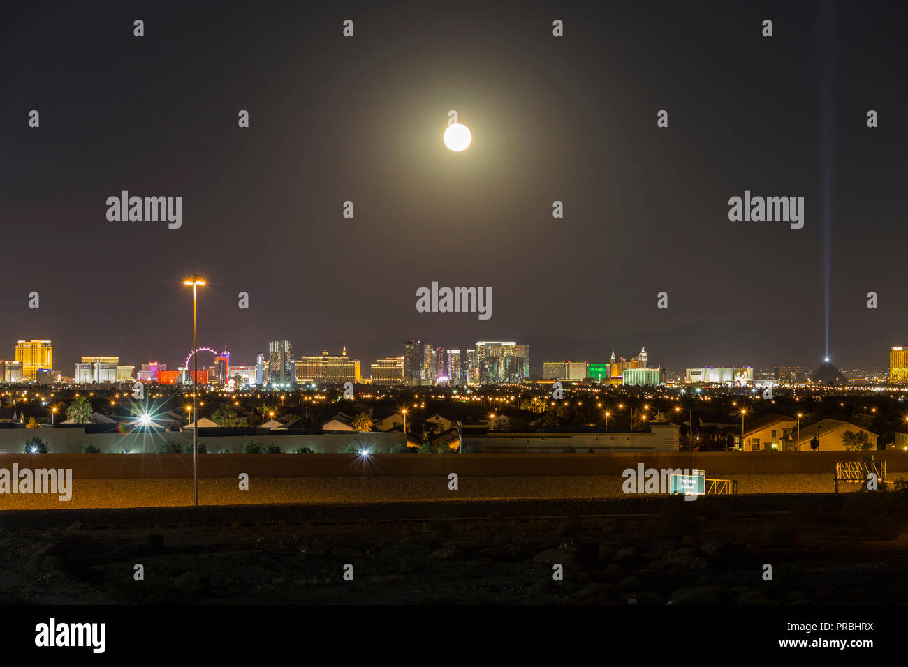Las Vegas, Nevada, USA - September 25, 2018:  Moon rising over the lights of the Las Vegas strip in Southern Nevada. Stock Photo