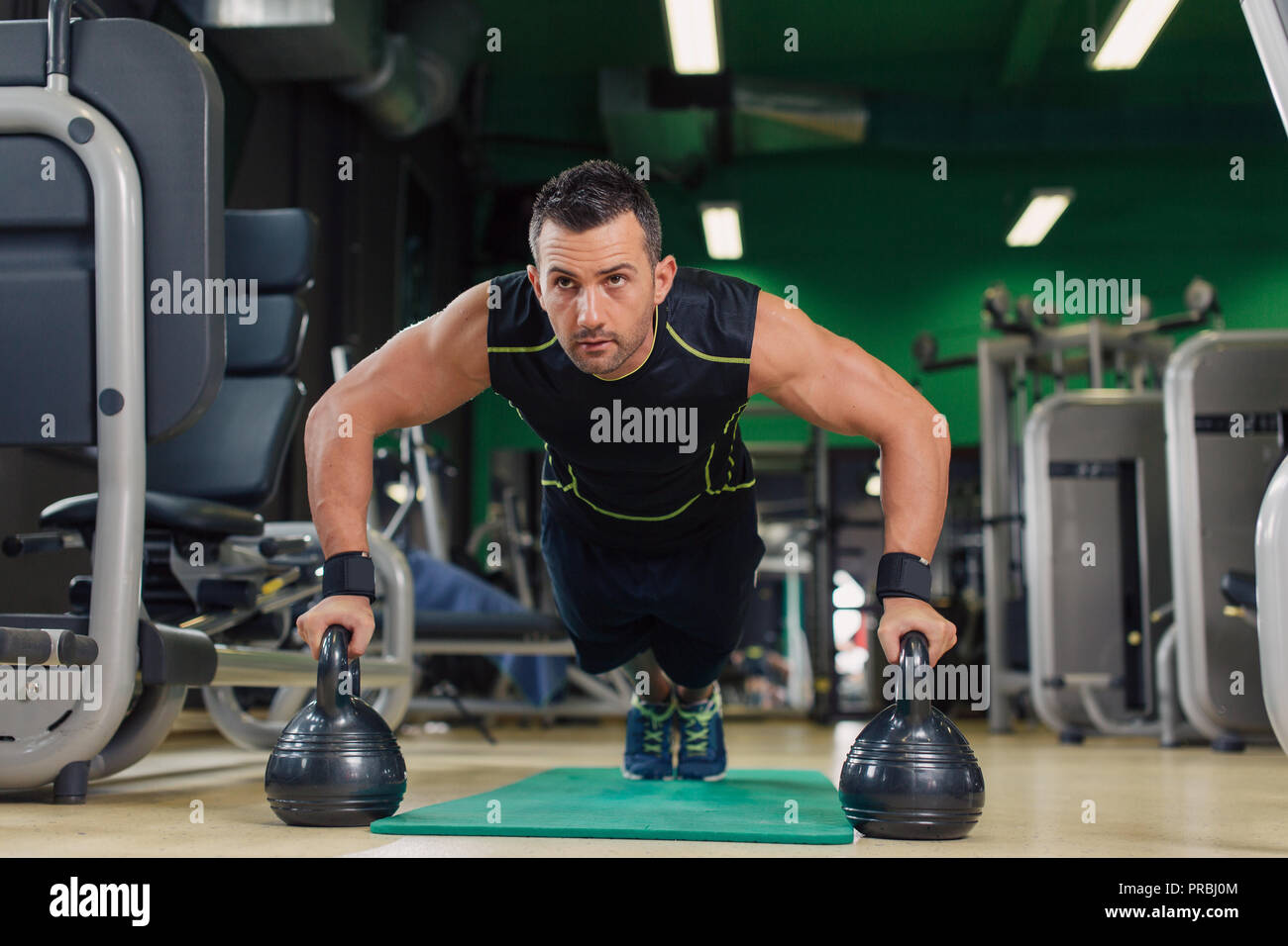 Man doing pushups in the gym on the floor Stock Photo - Alamy