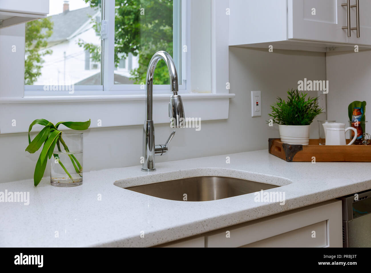 Beautiful modern kitchen interior with sink, cabinets, stainless steel in New Luxury Home Stock Photo