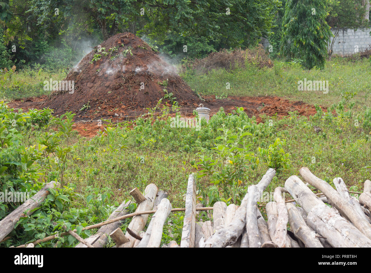 Charcoal making fire mound in Zanzibar Stock Photo - Alamy