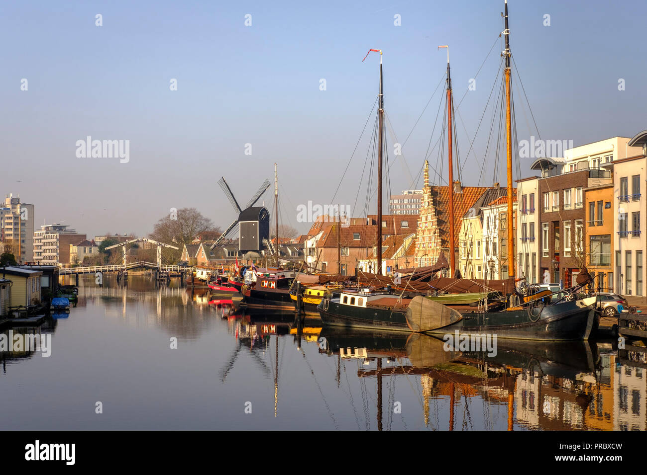 Netherlands,Leiden -view of the old town with the Molen De Valk-windmill with a working waterwheel and 1900s-style living spaces.Leiden municipal wind Stock Photo