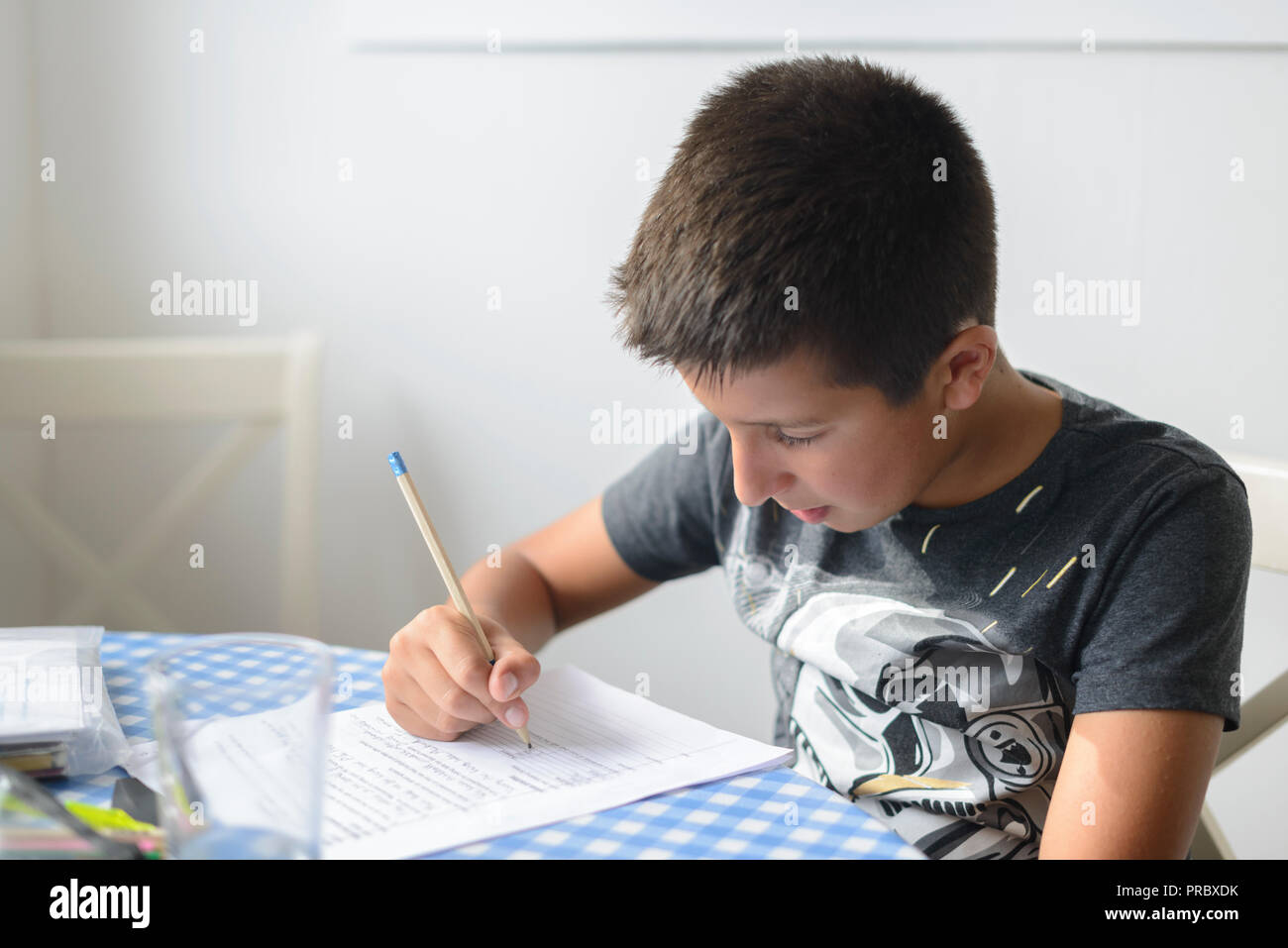 UK,Surrey-Child revising for 11+ (eleven plus) exams during summer holidays-selective focus Stock Photo