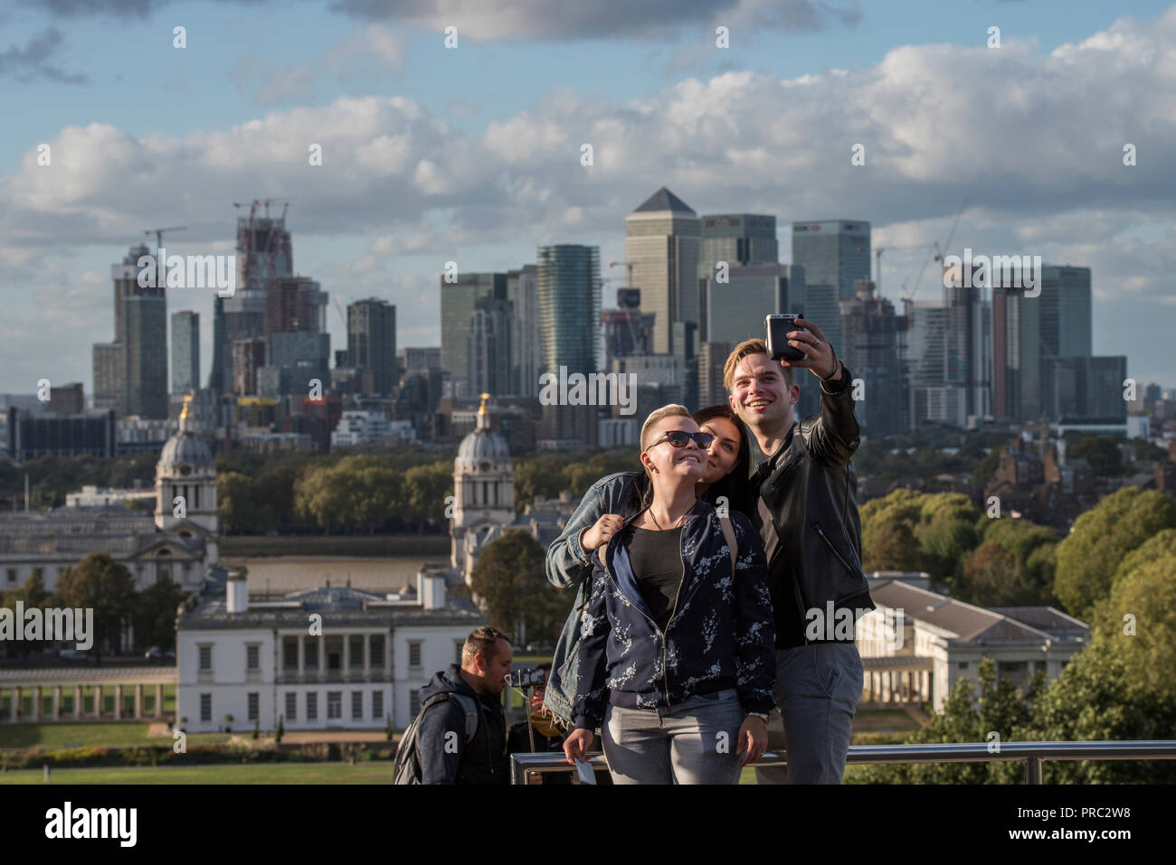 London Panorama from Greenwich Park, England UK. 22 September 2018 Taking selfie photographs with Canary Wharf as a backdrop. 20th and 21st cntury Can Stock Photo