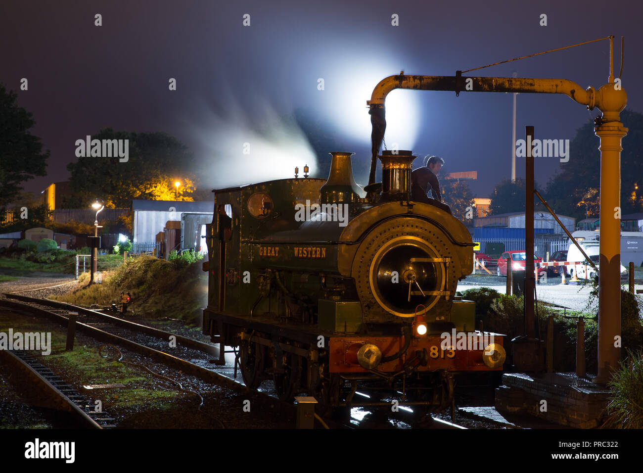 Landscape night shot of preserved steam engine 813 at water crane in the sidings Kidderminster station. SVR Autumn Steam Gala continues into the night Stock Photo