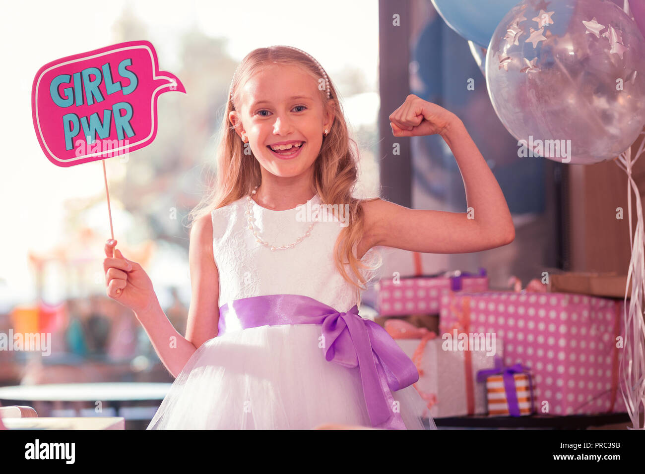 Positive girl showing her strength and laughing Stock Photo