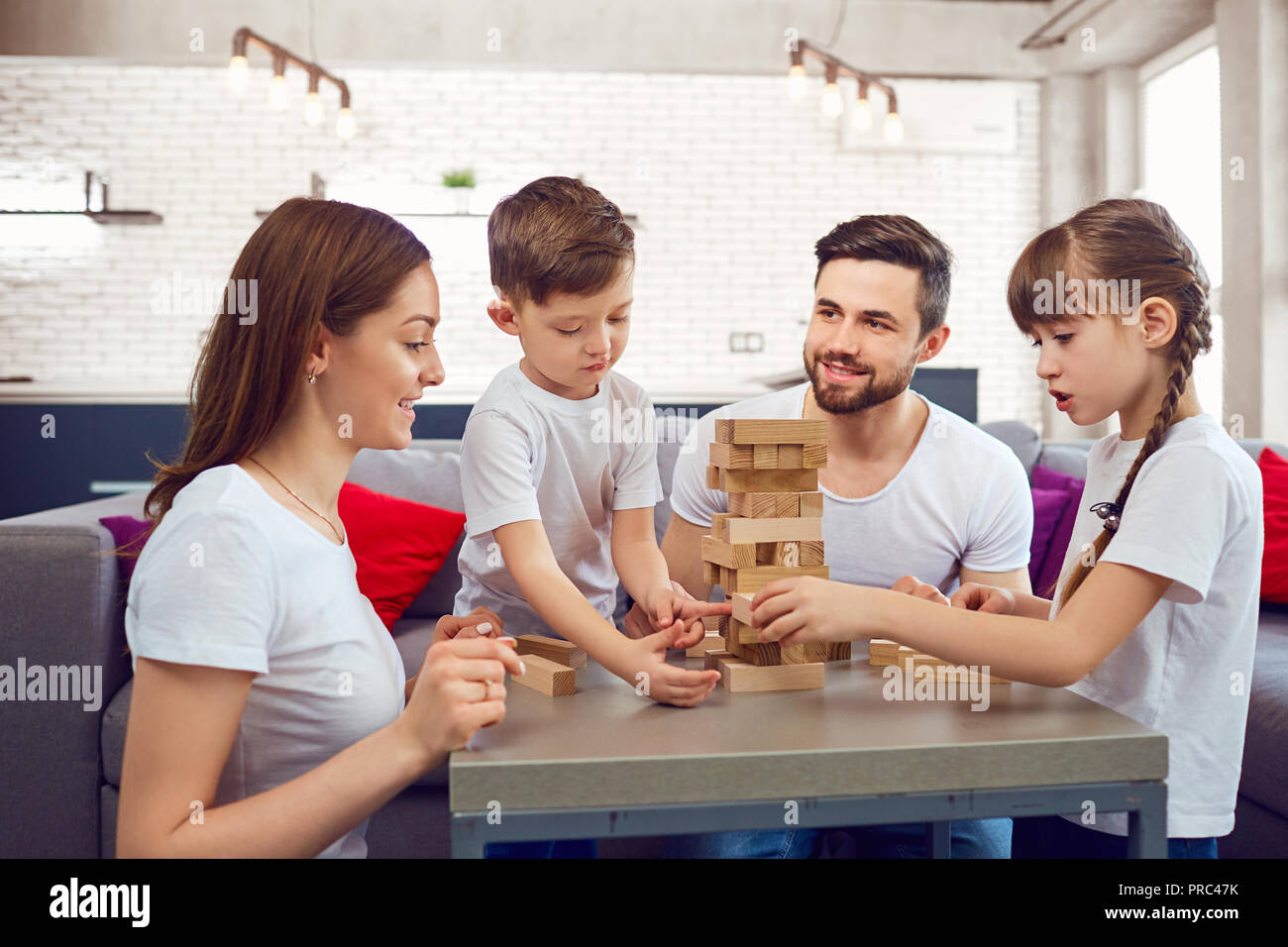 Happy family playing board games at home.  Stock Photo