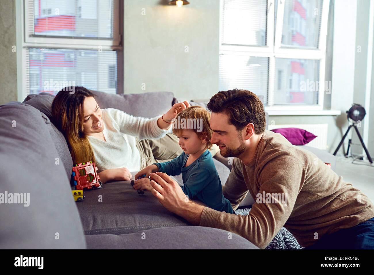 Happy family playing with the child  in the room. Stock Photo